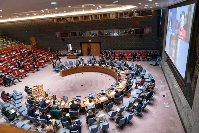 shutterstock_2060521844-3 Delegates seated around a circular conference table in a large chamber