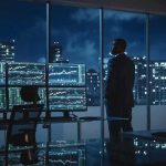 Trump Jr. Cash Bombshell Upends Polymarket Trader in a dark office with multiple stock monitors and city skyline at night
