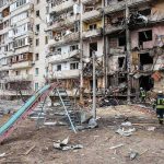 Russia’s Deadly Assault: Kyiv Tower Crumbles Damaged apartment building behind a playground slide