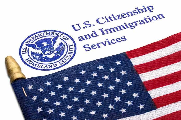 shutterstock_2132502127 U.S. flag beside U.S. Citizenship and Immigration Services document