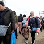 Mega-Typhoon Triggers 1.9M Evacuations Group of people in winter clothing standing in a line outdoors