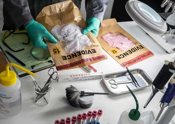shutterstock_2160065347 Forensic technician handling evidence bags on a lab table