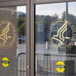 glass entrance doors with government agency seals