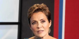 woman speaking into a microphone in a studio