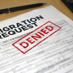 Here’s Another ‘Gem of an Illegal’ Biden Let Into U.S. Immigration request form with denied stamp on a desk