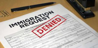 Here’s Another ‘Gem of an Illegal’ Biden Let Into U.S. Immigration request form with denied stamp on a desk