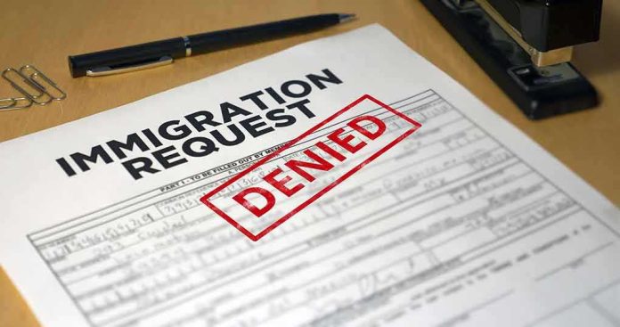 shutterstock_2240448611 Immigration request form with denied stamp on a desk