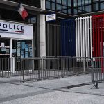 Festival Horror: Needle Attacks Ignite Chaos Police station entrance with barriers and French flag colors