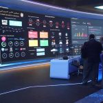 What Trump Says The Declassified Documents Reveal cybersecurity operations room with large data dashboards and people discussing