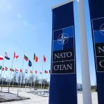 Nuclear Shuffle Rattles Europe NATO flags and banners outside headquarters