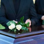 Trump’s STRIKING Tribute: Hidden Cost of Freedom mourners place white roses on a wooden casket