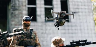 AI Missiles Brewing Under UN Embargo Quadcopter drone flying above soldiers in camouflage