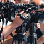 Is a Government Watchdog FUNDING Extremists?! television cameras on tripods at a media event
