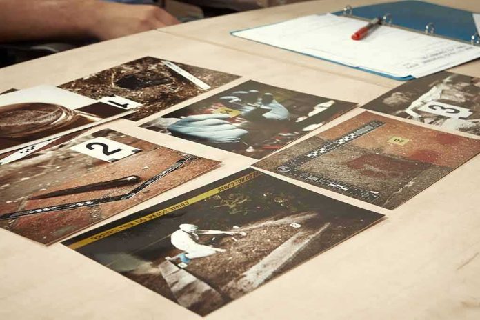 shutterstock_301002443 Crime scene photos laid out on a desk