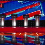 Don Lemon Calls Trump ‘Media Genius’ Debate stage with four podiums and colorful star backdrop