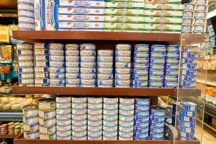 shutterstock_406484608 Grocery shelves stacked with assorted canned tuna and seafood