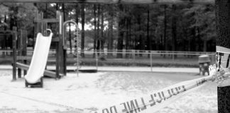Playground closed off with caution tape in black and white