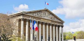 Pope Walks Into a 120 Year French Fight Neoclassical building with columns and French flags
