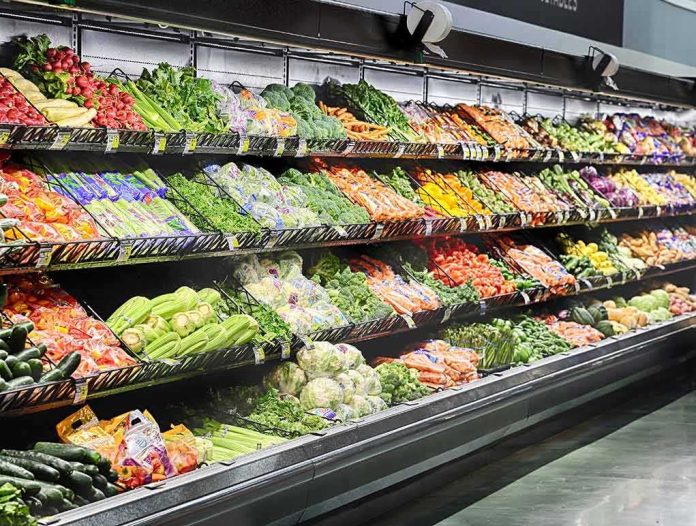 shutterstock_503073676-1 Grocery store produce aisle with stacked fresh vegetables
