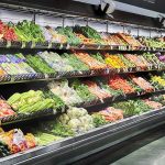FDA Finally Inspects Taylor Farms After Thousands Get Sick Grocery store produce aisle with stacked fresh vegetables