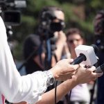 Shock Exit: UK PM Quits Reporters hold microphones during an outdoor press interview
