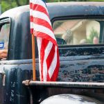 Democratic Socialist Aide Ties Patriotic Truck Ad to KKK American flag on the bed of a weathered vintage pickup truck