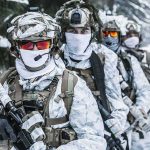 Greenland Deal Upends Arctic Rules Soldiers in white winter camouflage gear standing in a snowy forest