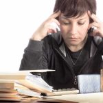 AOC’s Stealth White House Play Begins Person stressed while working with paperwork and calculator