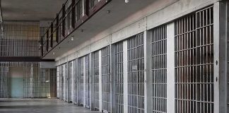 prison cell block with metal barred doors