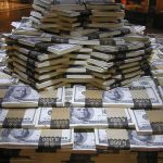 Report Fraud and Pocket Up to $30,000 Stacks of U.S. hundred-dollar bills arranged in a pyramid