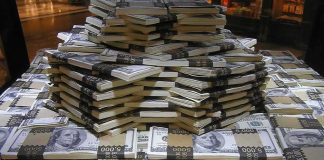 Report Fraud and Pocket Up to $30,000 Stacks of U.S. hundred-dollar bills arranged in a pyramid