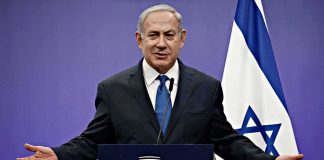 Netanyahu Lands a Major ENDORSEMENT man in suit speaking at a podium with Israeli flag
