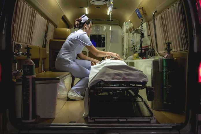 shutterstock_1107774719 Nurse attending patient on stretcher inside ambulance