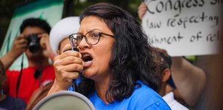 Rashida Tlaib FUMES at Voters on Tape Woman speaking into a megaphone at a protest