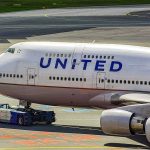 United Airlines Boeing 747 being towed on an airport taxiway