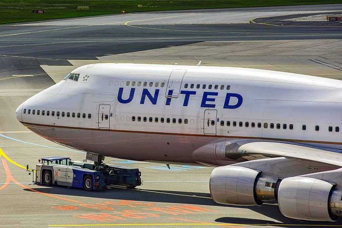 United Airlines Boeing 747 being towed on an airport taxiway