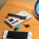 Vape BAN Could Send Ex-Smokers Back to Cigarettes vape pen and pods on a wooden nightstand