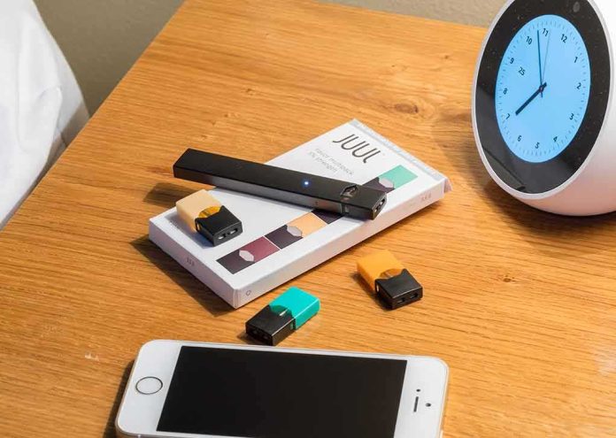 shutterstock_1164563215 vape pen and pods on a wooden nightstand