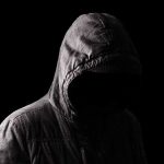 NFL Sideline Star Takes Aim at Somali GANGS Hooded figure in shadow on black background