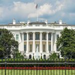 White House Opens Door to AI BOOM The White House north facade behind a black iron fence