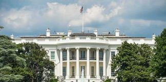White House Opens Door to AI BOOM The White House north facade behind a black iron fence