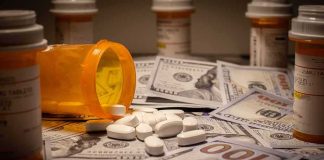 Autism Care SCAM Hit With 26 Counts Prescription pill bottle and white tablets on scattered US dollar bills