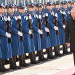 Putin Budgets for YEARS More War Vladimir Putin walks past an honor guard; Genaro García Luna and Darius Kilgo not visible