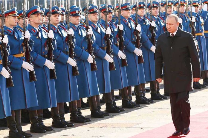 shutterstock_1298363227 Vladimir Putin walks past an honor guard; Genaro García Luna and Darius Kilgo not visible