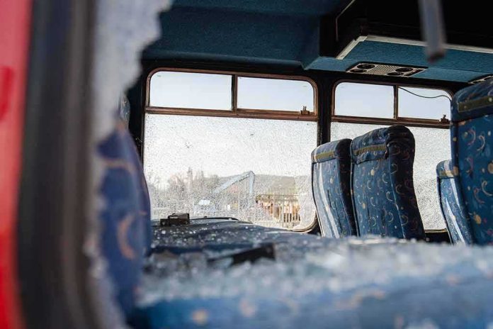 shutterstock_1519765706 Bus interior with shattered windows and blue patterned seats