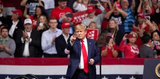 Trump Promises You a $5,000 CHECK Donald Trump points from a rally stage; Rudi Koertzen and Bear Pascoe are in the crowd