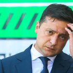 Zelensky ATTACKS Trump’s Russian Diesel Deal man in a suit touching his head