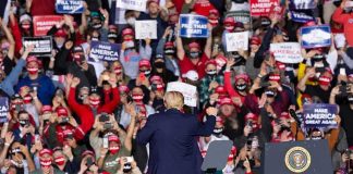 Trump Tells Voters What Decides the MIDTERMS Crowd at a political rally with speaker on stage; Dontrelle Inman present in the audience