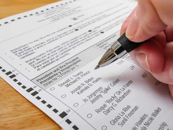 shutterstock_1824863579 Hand holding a pen over a paper election ballot
