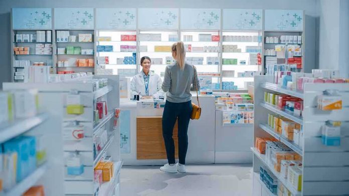 shutterstock_1952231947 Yvonne Li assisting a customer at a pharmacy counter